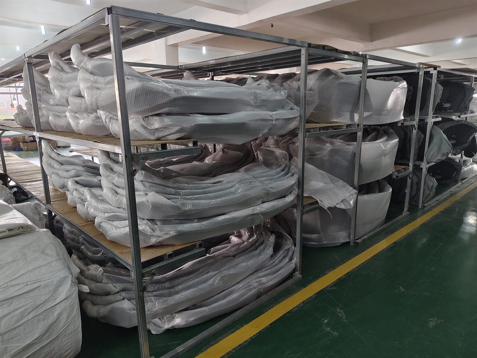 Wrapped automotive body parts stored on supplier warehouse racks